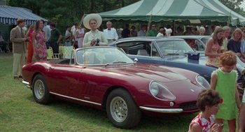 Movie still from “The Thomas Crown Affair” (1968), directed by Norman Jewison – A woman standing next to a red sports car; Wide shot, High angle