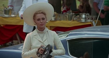 Movie still from “The Thomas Crown Affair” (1968), directed by Norman Jewison – A woman wearing a white hat and holding a camera; Medium shot, Low angle
