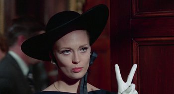 Movie still from “The Thomas Crown Affair” (1968), directed by Norman Jewison – A woman in a black hat and a white glove; Close Up shot, Low angle