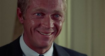 Movie still from “The Thomas Crown Affair” (1968), directed by Norman Jewison – A person wearing a suit and tie; Close Up shot, Over the shoulder angle