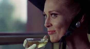 Movie still from “The Thomas Crown Affair” (1968), directed by Norman Jewison – A woman holding a glass of wine in her hand; Close Up shot, Low angle