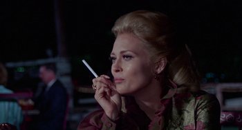 Movie still from “The Thomas Crown Affair” (1968), directed by Norman Jewison – A woman is holding a cigarette in her mouth; Close Up shot, Low angle