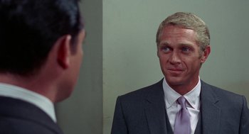 Movie still from “The Thomas Crown Affair” (1968), directed by Norman Jewison – A man wearing a suit and tie looking at himself in the mirror; Close Up shot, Over the shoulder angle