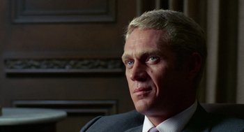 Movie still from “The Thomas Crown Affair” (1968), directed by Norman Jewison – A man in a suit and tie; Close Up shot, Over the shoulder angle