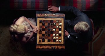 Movie still from “The Thomas Crown Affair” (1968), directed by Norman Jewison – A man and a woman playing a game of chess; Medium shot, Overhead angle