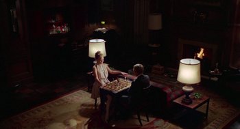 Movie still from “The Thomas Crown Affair” (1968), directed by Norman Jewison – A man and a woman are playing a game of chess; Wide shot, High angle