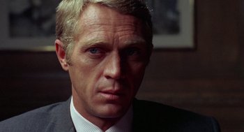 Movie still from “The Thomas Crown Affair” (1968), directed by Norman Jewison – A person wearing a suit and tie; Close Up shot, Over the shoulder angle