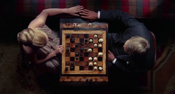 Movie still from “The Thomas Crown Affair” (1968), directed by Norman Jewison – A man and a woman are playing a game of chess; Medium shot, Overhead angle