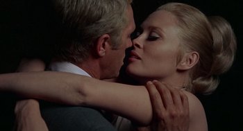 Movie still from “The Thomas Crown Affair” (1968), directed by Norman Jewison – A man and a woman are kissing in a dark room; Close Up shot, Over the shoulder angle