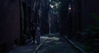 Movie still from “The Thomas Crown Affair” (1968), directed by Norman Jewison – Two people standing on the side of a street; Extreme Wide shot, High angle