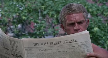 Movie still from “The Thomas Crown Affair” (1968), directed by Norman Jewison – A man reading a newspaper in front of a tree; Close Up shot, Low angle
