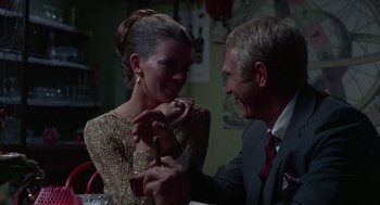 Movie still from “The Thomas Crown Affair” (1968), directed by Norman Jewison – A man and a woman sitting at a dinner table; Close Up shot, Over the shoulder angle
