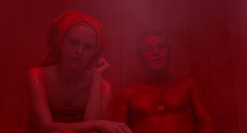 Movie still from “The Thomas Crown Affair” (1968), directed by Norman Jewison – A man and a woman sitting in a red room; Medium shot, Low angle