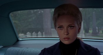 Movie still from “The Thomas Crown Affair” (1968), directed by Norman Jewison – A woman sitting in the back seat of a car; Close Up shot, Over the shoulder angle