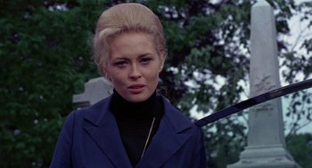 Movie still from “The Thomas Crown Affair” (1968), directed by Norman Jewison – A woman in a blue coat and a black top; Close Up shot, Low angle