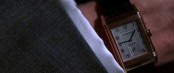 Movie still from “The Thomas Crown Affair” (1999), directed by John McTiernan – View of a tie and a watch; Extreme Close Up shot, Overhead angle
