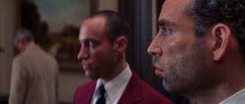 Movie still from “The Thomas Crown Affair” (1999), directed by John McTiernan – A man in a red jacket and a man in a white shirt; Close Up shot, Low angle