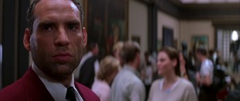 Movie still from “The Thomas Crown Affair” (1999), directed by John McTiernan – A group of people standing in front of a painting; Close Up shot, Low angle