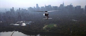 Movie still from “The Thomas Crown Affair” (1999), directed by John McTiernan – A helicopter flying over a large body of water; Extreme Wide shot, High angle