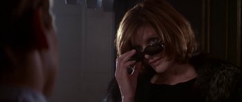Movie still from “The Thomas Crown Affair” (1999), directed by John McTiernan – A woman wearing sunglasses and holding a cell phone up to her face; Close Up shot, Low angle