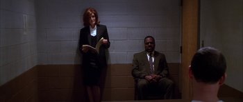 Movie still from “The Thomas Crown Affair” (1999), directed by John McTiernan – A man and a woman are sitting on a bench; Wide shot, Low angle