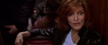 Movie still from “The Thomas Crown Affair” (1999), directed by John McTiernan – A person sitting in front of a window; Close Up shot, Over the shoulder angle