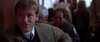 Movie still from “The Thomas Crown Affair” (1999), directed by John McTiernan – A person wearing a suit and tie; Close Up shot, Over the shoulder angle