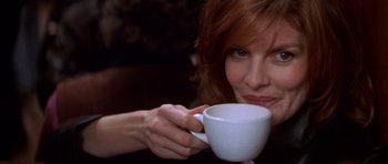 Movie still from “The Thomas Crown Affair” (1999), directed by John McTiernan – A person holding a cup of coffee; Close Up shot, Low angle