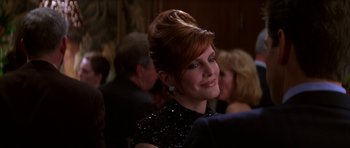 Movie still from “The Thomas Crown Affair” (1999), directed by John McTiernan – A person wearing a black dress; Close Up shot, Over the shoulder angle