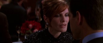 Movie still from “The Thomas Crown Affair” (1999), directed by John McTiernan – A person wearing a black dress; Close Up shot, Over the shoulder angle