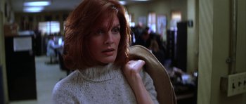 Movie still from “The Thomas Crown Affair” (1999), directed by John McTiernan – A person with red hair; Close Up shot, Low angle