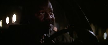 Movie still from “The Thomas Crown Affair” (1999), directed by John McTiernan – A man with a gun in his mouth in the dark; Close Up shot, Low angle