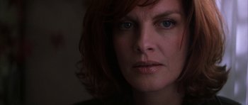 Movie still from “The Thomas Crown Affair” (1999), directed by John McTiernan – A woman's face in the dark; Close Up shot, Over the shoulder angle