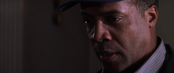 Movie still from “The Thomas Crown Affair” (1999), directed by John McTiernan – A person wearing a hat; Close Up shot, Over the shoulder angle
