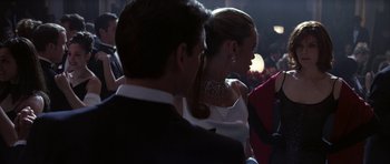 Movie still from “The Thomas Crown Affair” (1999), directed by John McTiernan – A man and a woman in formal wear at an event; Medium shot, Over the shoulder angle