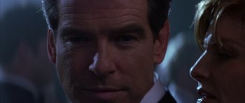 Movie still from “The Thomas Crown Affair” (1999), directed by John McTiernan – A person wearing a suit and tie; Close Up shot, Over the shoulder angle