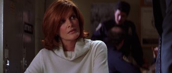 Movie still from “The Thomas Crown Affair” (1999), directed by John McTiernan – A person wearing a white shirt; Close Up shot, Over the shoulder angle