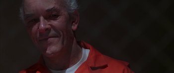 Movie still from “The Thomas Crown Affair” (1999), directed by John McTiernan – An older man wearing an orange jacket and white shirt; Close Up shot, Low angle