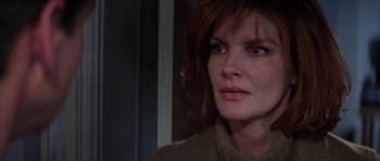 Movie still from “The Thomas Crown Affair” (1999), directed by John McTiernan – A person looking at the camera; Close Up shot, Over the shoulder angle