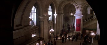 Movie still from “The Thomas Crown Affair” (1999), directed by John McTiernan – A group of people standing in a large building; Extreme Wide shot, High angle