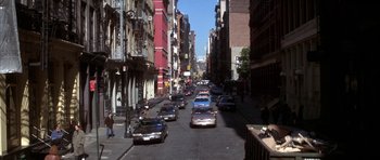 Movie still from “The Thomas Crown Affair” (1999), directed by John McTiernan – A city street filled with lots of traffic; Extreme Wide shot, High angle