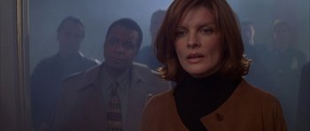 Movie still from “The Thomas Crown Affair” (1999), directed by John McTiernan – A man and a woman are standing in a dark room; Close Up shot, Low angle