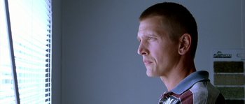 Movie still from “The Three Burials of Melquiades Estrada” (2005), directed by Tommy Lee Jones – A person wearing a suit and tie; Close Up shot, Low angle