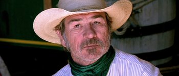 Movie still from “The Three Burials of Melquiades Estrada” (2005), directed by Tommy Lee Jones – A person wearing a cowboy hat; Close Up shot, Low angle