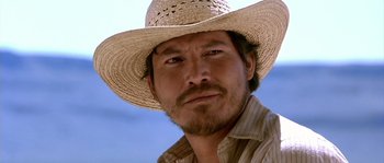 Movie still from “The Three Burials of Melquiades Estrada” (2005), directed by Tommy Lee Jones – A person wearing a straw hat; Close Up shot, Low angle
