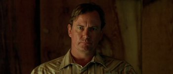 Movie still from “The Three Burials of Melquiades Estrada” (2005), directed by Tommy Lee Jones – A person wearing a striped shirt; Close Up shot, Low angle