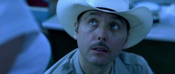 Movie still from “The Three Burials of Melquiades Estrada” (2005), directed by Tommy Lee Jones – A person wearing a cowboy hat; Close Up shot, Low angle