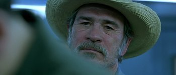 Movie still from “The Three Burials of Melquiades Estrada” (2005), directed by Tommy Lee Jones – An older man wearing a straw hat and a beard; Close Up shot, Over the shoulder angle
