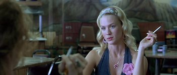 Movie still from “The Three Burials of Melquiades Estrada” (2005), directed by Tommy Lee Jones – A beautiful blonde woman sitting in a chair; Close Up shot, Over the shoulder angle