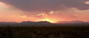 Movie still from “The Three Burials of Melquiades Estrada” (2005), directed by Tommy Lee Jones – The sun is setting over a desert plain; Extreme Wide shot, Low angle